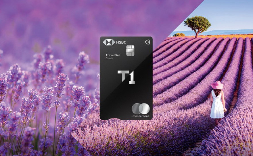 An HSBC TravelOne credit card overlaid on images of purple flowers in a field